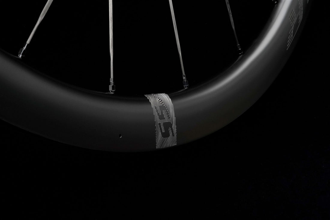 Close-up of a carbon rim on a black background, showing the depth of its profile