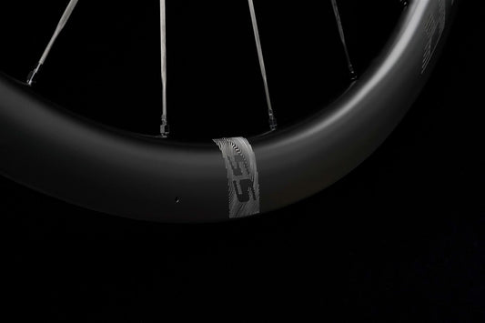 Close-up of a carbon rim on a black background, showing the depth of its profile