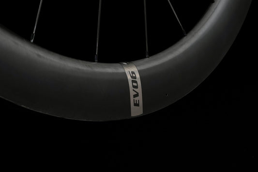 Close-up of a carbon rim on a black background, the tyre bed and rim wall in view