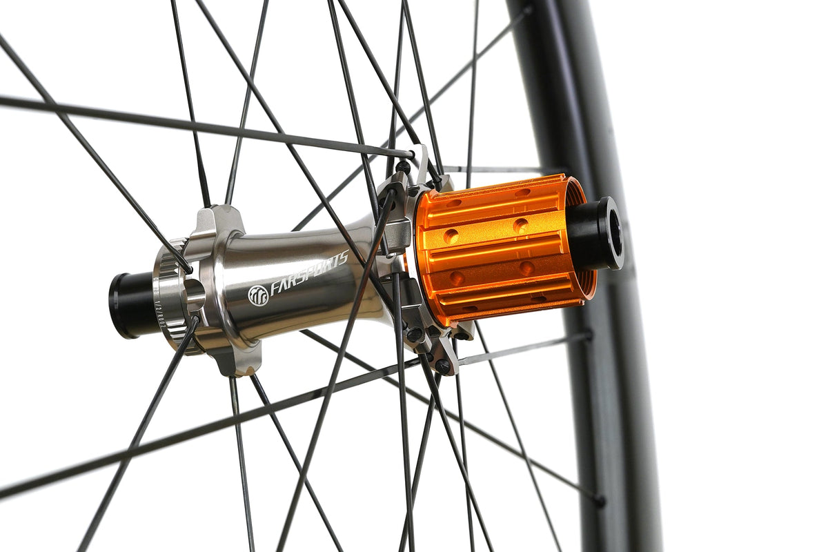 Farsports CH01 rear hub close-up, orange freehub body and Alpina Ultralite steel spokes
