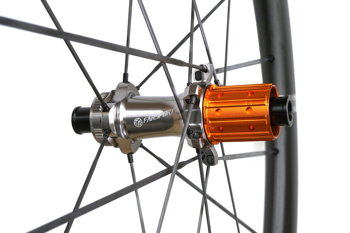 Farsports SH01 rear hub close-up, orange freehub body and bladed carbon spokes